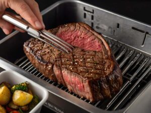 Placing New York Strip Steak in Air Fryer Basket