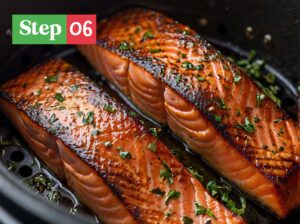 Salmon fillets cooking in air fryer, flipping halfway