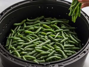 Arranging green beans in air fryer basket for even cooking