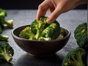 Adding a pinch of salt to cooked sesame ginger broccoli