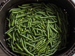 Spreading green beans in air fryer basket