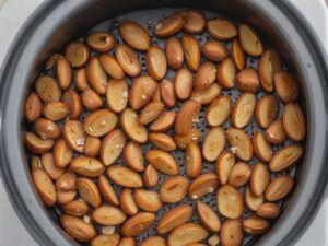 Golden toasted almonds in air fryer basket