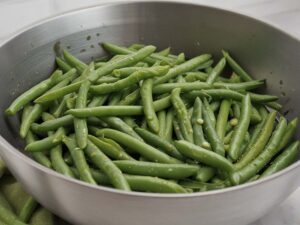 Rinsing green beans under cold water in colander