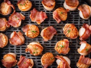 Arranging bacon-wrapped scallops in the air fryer basket