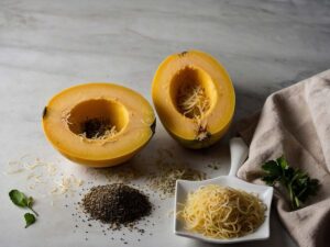 Seasoning cut halves of spaghetti squash with olive oil and spices