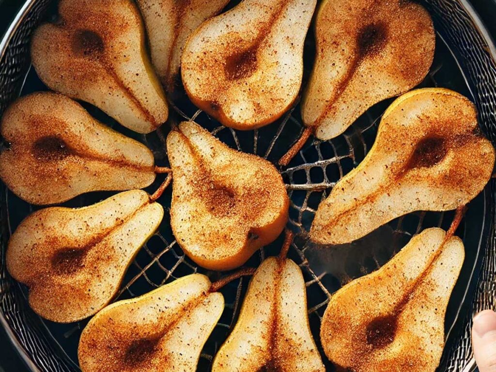 Placing coated pears in the air fryer basket for cook