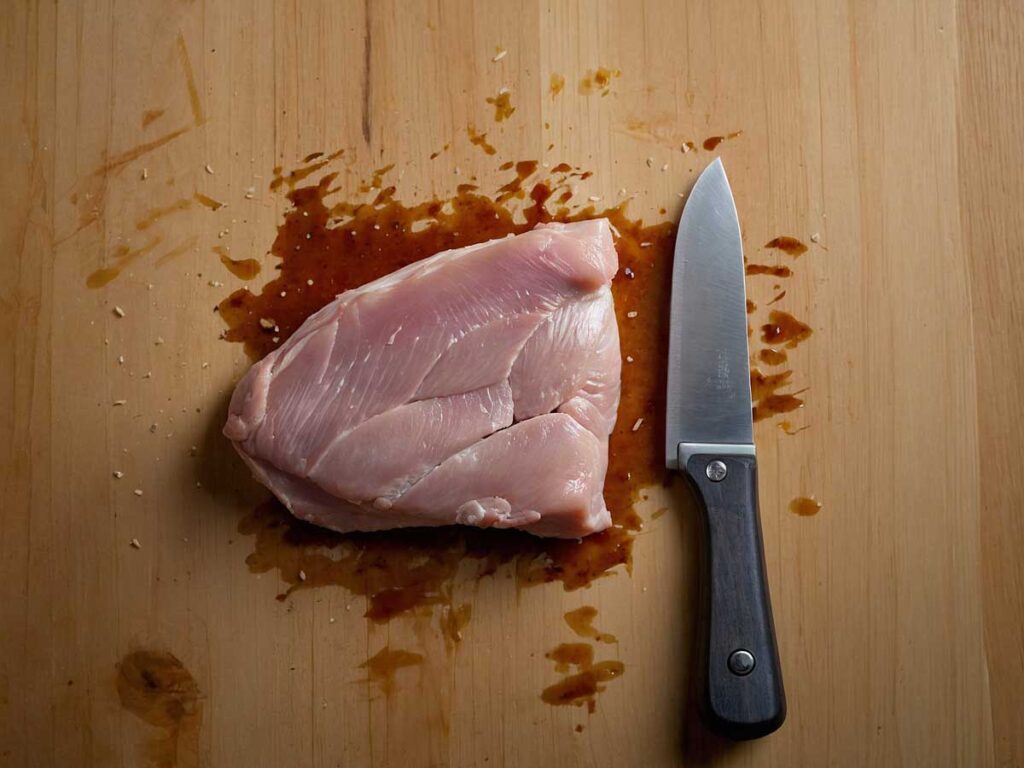 Butterflying a chicken breast to create a pocket