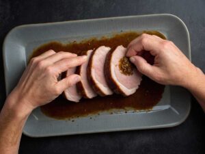 Rubbing seasoning mixture on pork loin