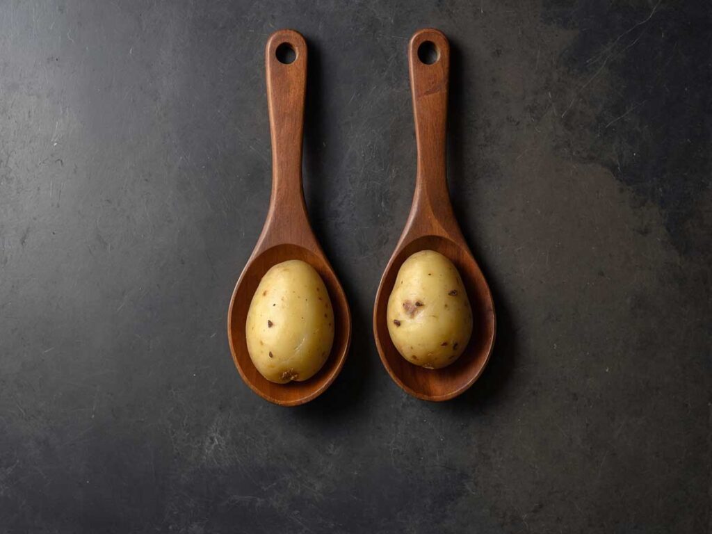 Placing Potatoes Between Wooden Spoons